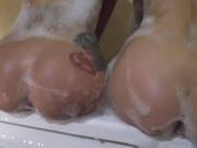 Cute girls are having a relaxing bath together and taking turns sucking dick before getting fucked