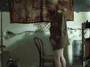 A naked red-haired model poses for a photographer in Dreams (1993)